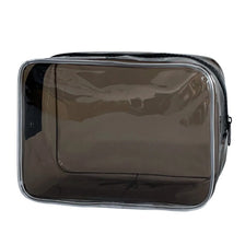 A transparent PVC travel makeup bag with a black zipper closure.