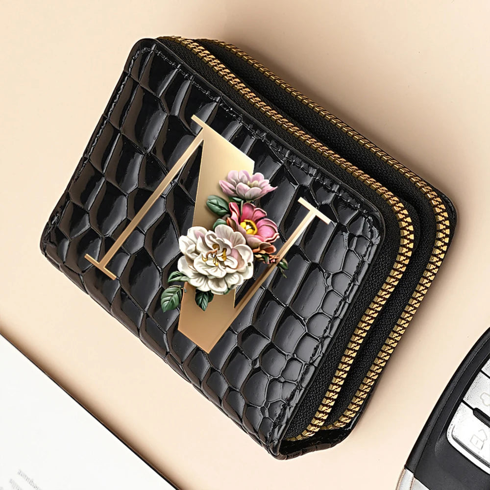 A black PU leather double-zip clutch wallet with a gold accent and a floral cartoon print.