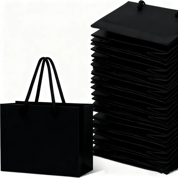 A stack of black thick paper gift bags with rope handles.