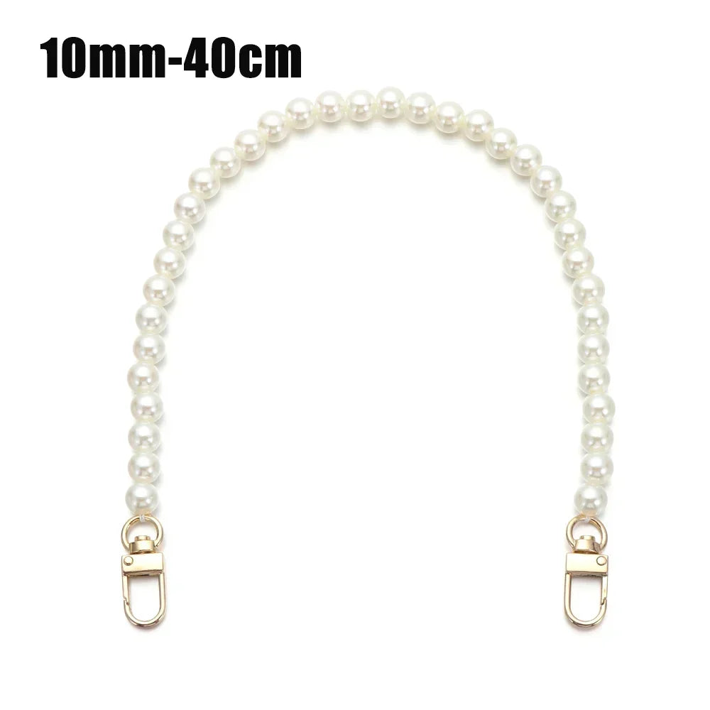 A strand of small white pearls used as a strap for a handbag or purse.