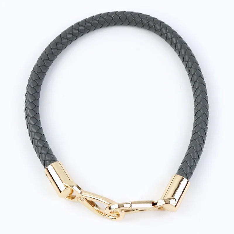 A black PU leather replacement bag strap with gold-toned metal buckles.
