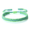 Handmade braided rope bracelet with colorful green and blue fibers.