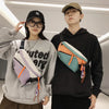 A young man and woman posing with a unisex nylon chest rig bag in orange and teal colors.