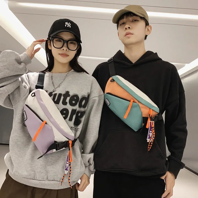 A young man and woman posing with a unisex nylon chest rig bag in orange and teal colors.