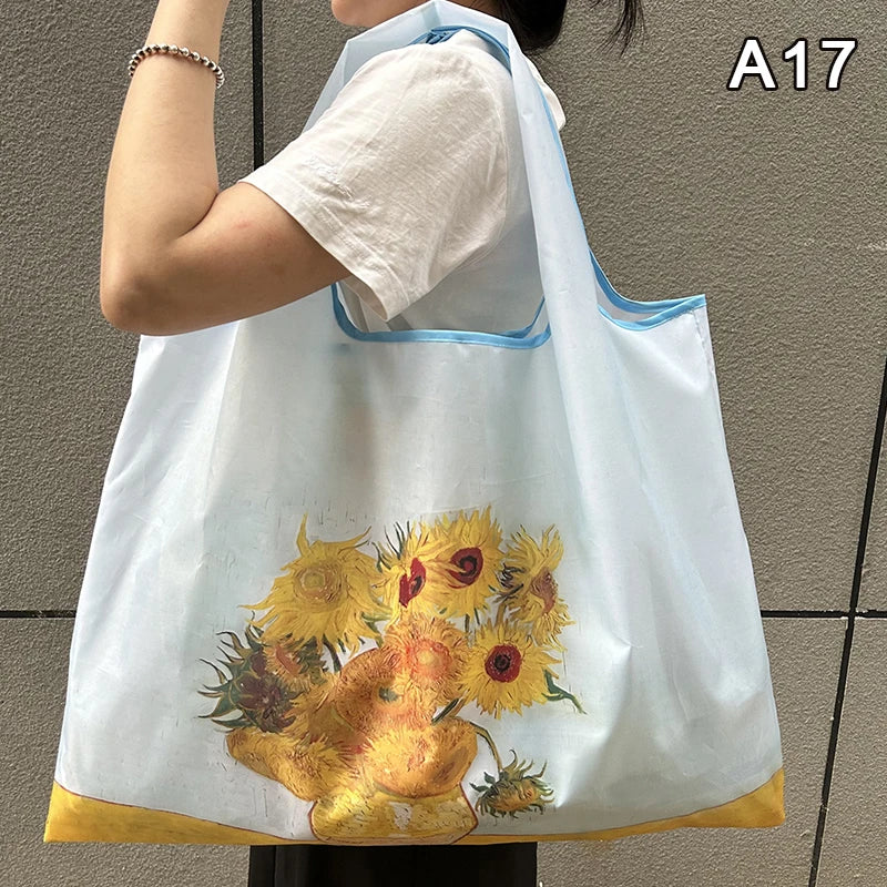 A light blue nylon shopping tote bag featuring a yellow floral design, shown from the front.