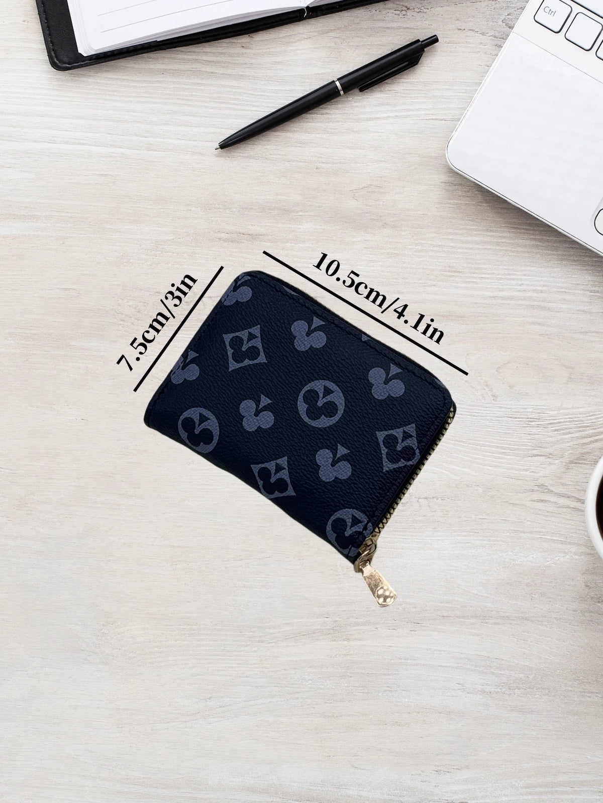 A dark blue zippered card holder wallet is shown on a light wooden surface with dimension lines.