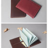 A deep burgundy genuine cowhide leather passport and ticket holder displayed in two views.