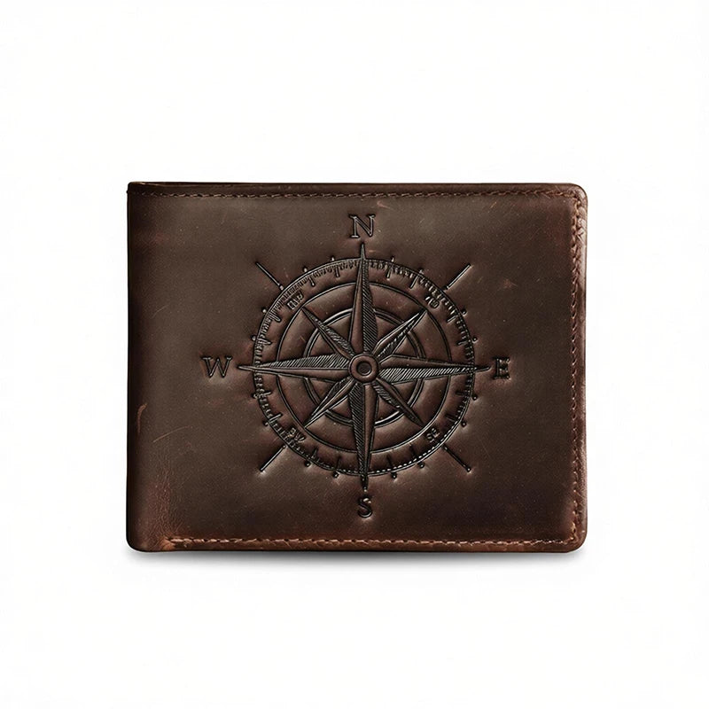 A dark brown leather wallet featuring an engraved compass design on the surface.