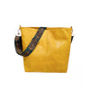 A mustard yellow leather crossbody bag with a patterned strap.