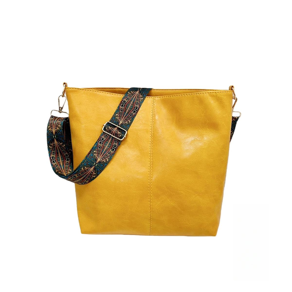 A mustard yellow leather crossbody bag with a patterned strap.