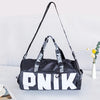 A black and white Nike shoulder bag with black straps, featuring the brand name PNIK printed on the front.