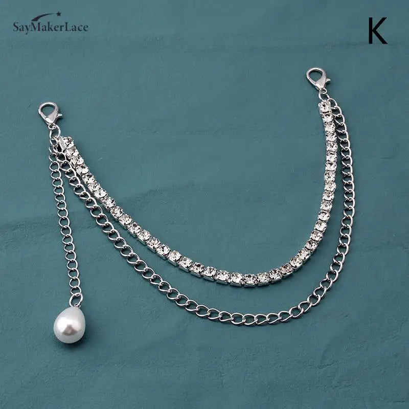 Silver multi-layer metal chain strap charm with a pearl dangle on a dark blue background