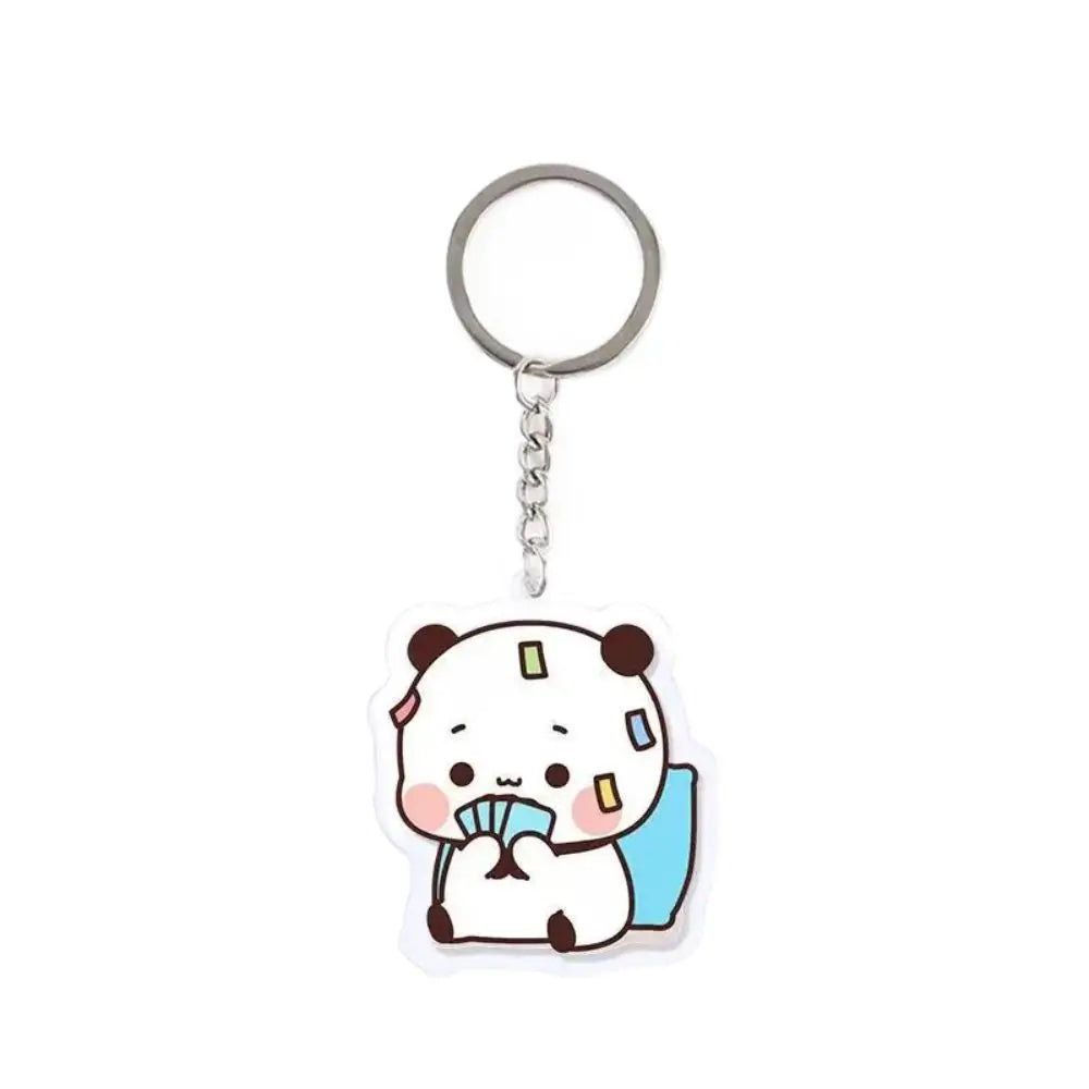 A white cartoon panda resin keychain charm with a blue accent.