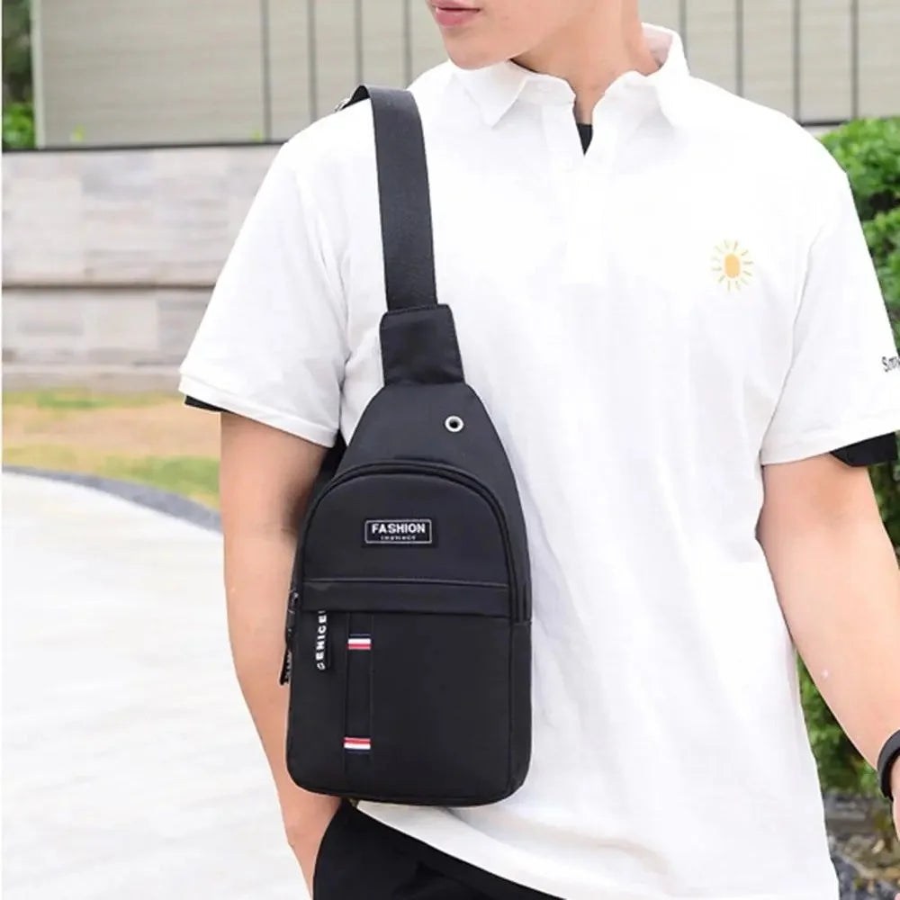 A man wearing a white polo shirt and carrying a black waterproof crossbody fanny pack.