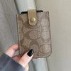 A hand holds a brown patterned PU leather card holder purse with a leather flap and stud.