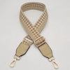 A beige braided nylon bag strap with a checkered pattern and metal hooks.