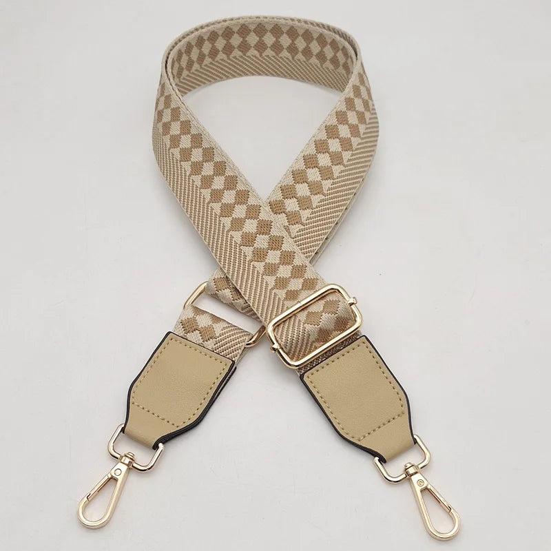 A beige braided nylon bag strap with a checkered pattern and metal hooks.