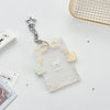 Clear acrylic photocard holder with a yellow ribbon and a silver star charm