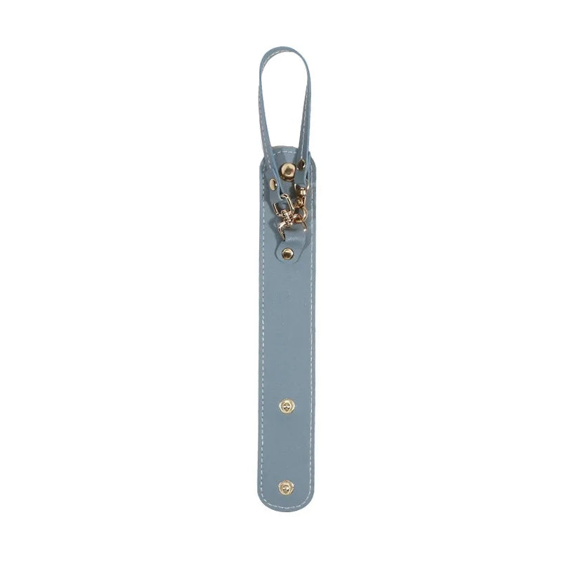 A vintage leather glove holder strap in a muted blue-gray color with brass hardware.