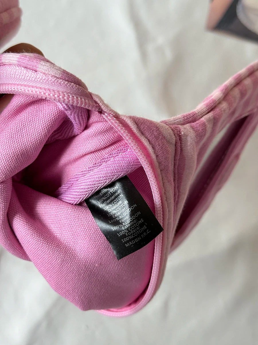 Pink striped makeup bag with a flip-top mirror shown in a close-up view.