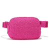 A pink fleece crossbody belt bag with a zipper and pink strap.