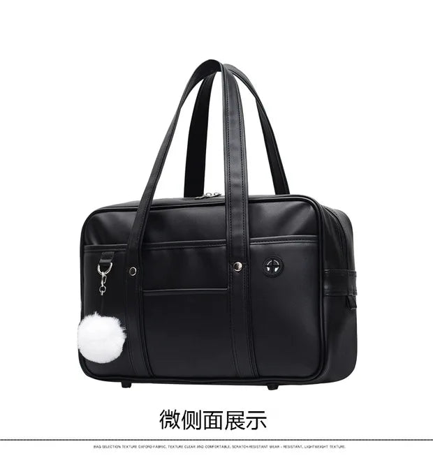 Black leather preppy shoulder bag with white fluffy trim shown from the front