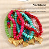 Handcrafted necklace featuring a colorful arrangement of matte resin round beads with gold heart charms.