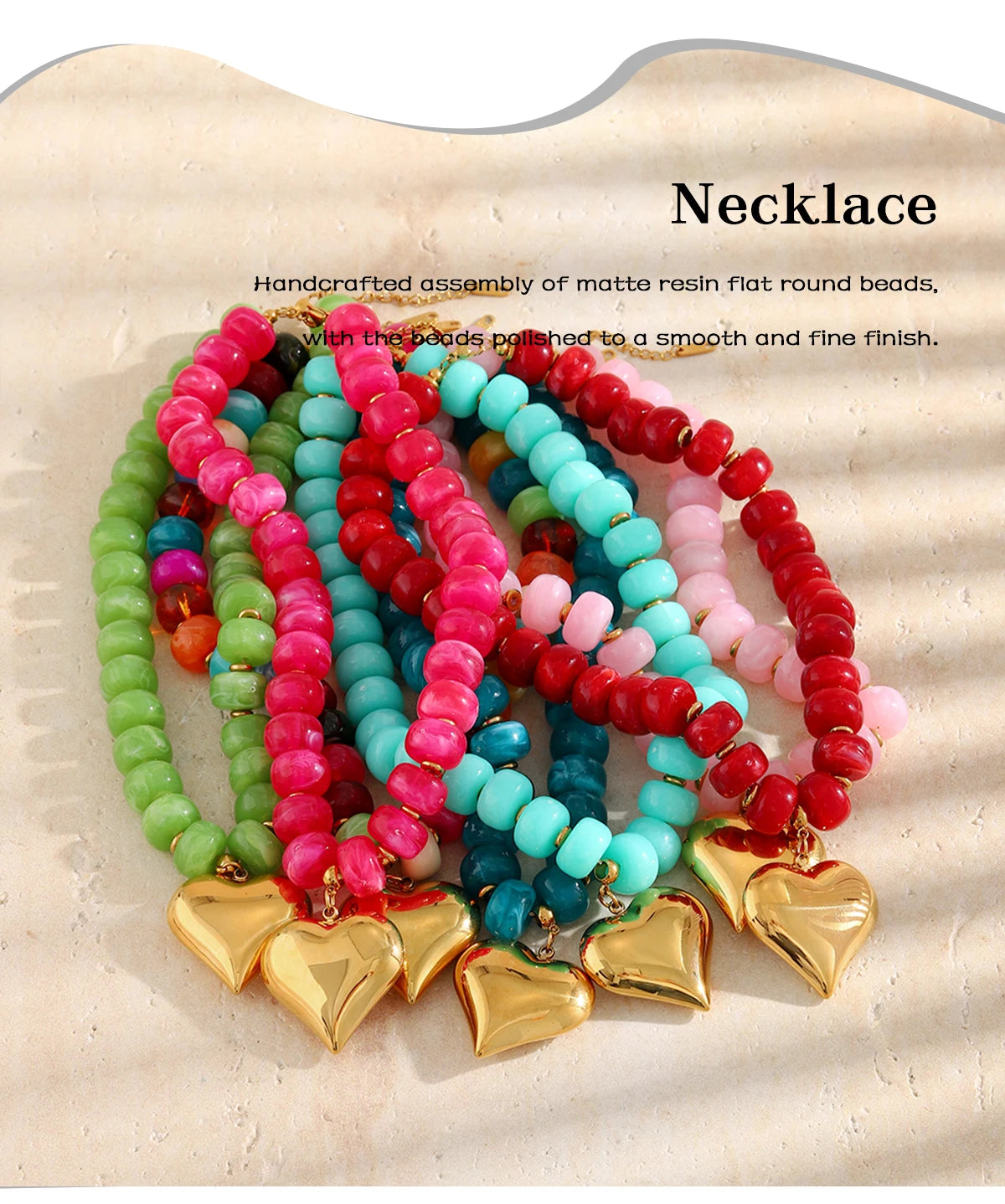 Handcrafted necklace featuring a colorful arrangement of matte resin round beads with gold heart charms.