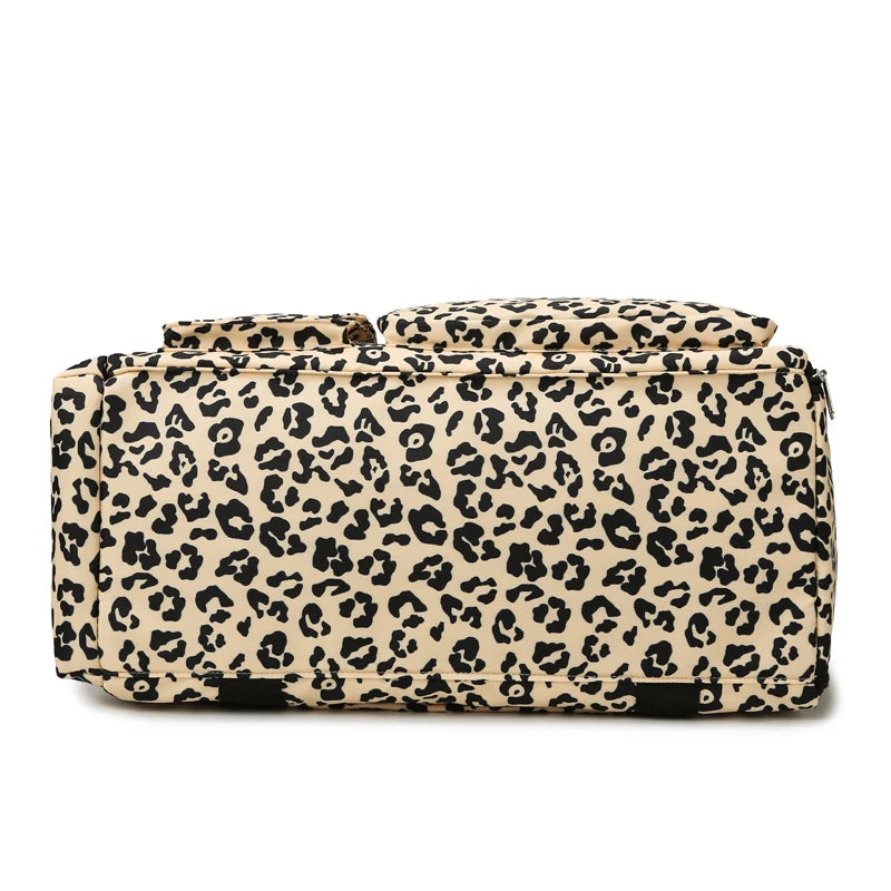 A leopard print travel duffel bag with a shoe compartment.