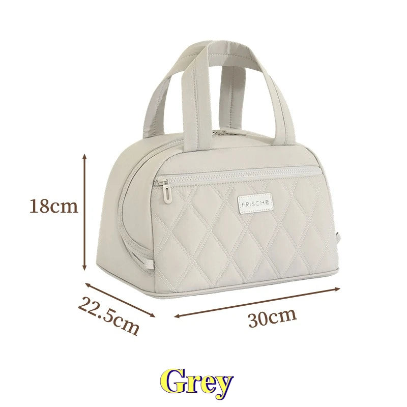 A light grey quilted insulated PU leather lunch tote with a flap and handles.