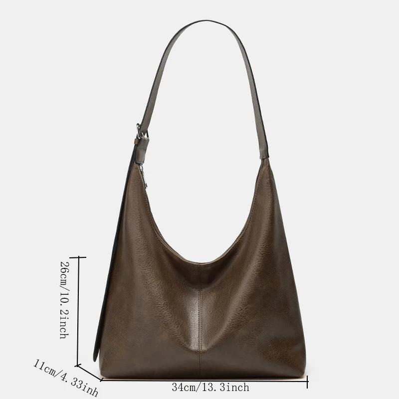 A brown soft PU leather retro tote bag with a zipper closure shown against a white background.