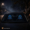 Two gothic skull headrest covers with a blue glow design are visible inside a dark car at night.