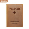 A brown genuine leather passport holder with embossed text and a silhouette of an airplane.