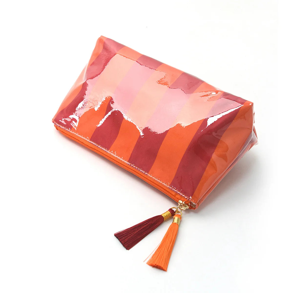 Orange and pink striped waterproof cosmetic travel pouch with gold fringe