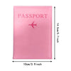 A pink leather passport holder with a silver airplane emblem.