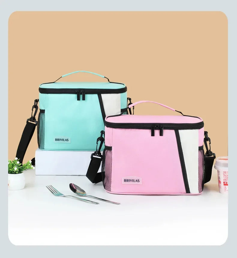 Pink and teal insulated reusable lunch bags with adjustable straps displayed on a white surface.