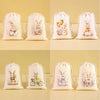 A set of six light pink drawstring gift bags featuring various Easter bunny and floral patterns.
