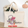 A beige canvas tote bag featuring a pink heart, stethoscope, and the name Madison with space for a personalized name.
