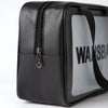 Black leather waterproof travel toiletry bag with a silver zipper and a white label.