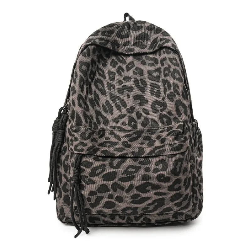 A dark gray leopard print canvas backpack shown from the front.