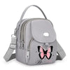 Sac bandoulière floral gris clair avec fermeture éclair et sangle.