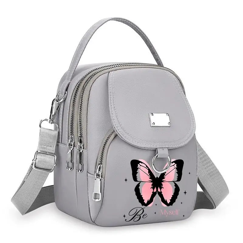 Sac bandoulière floral gris clair avec fermeture éclair et sangle.