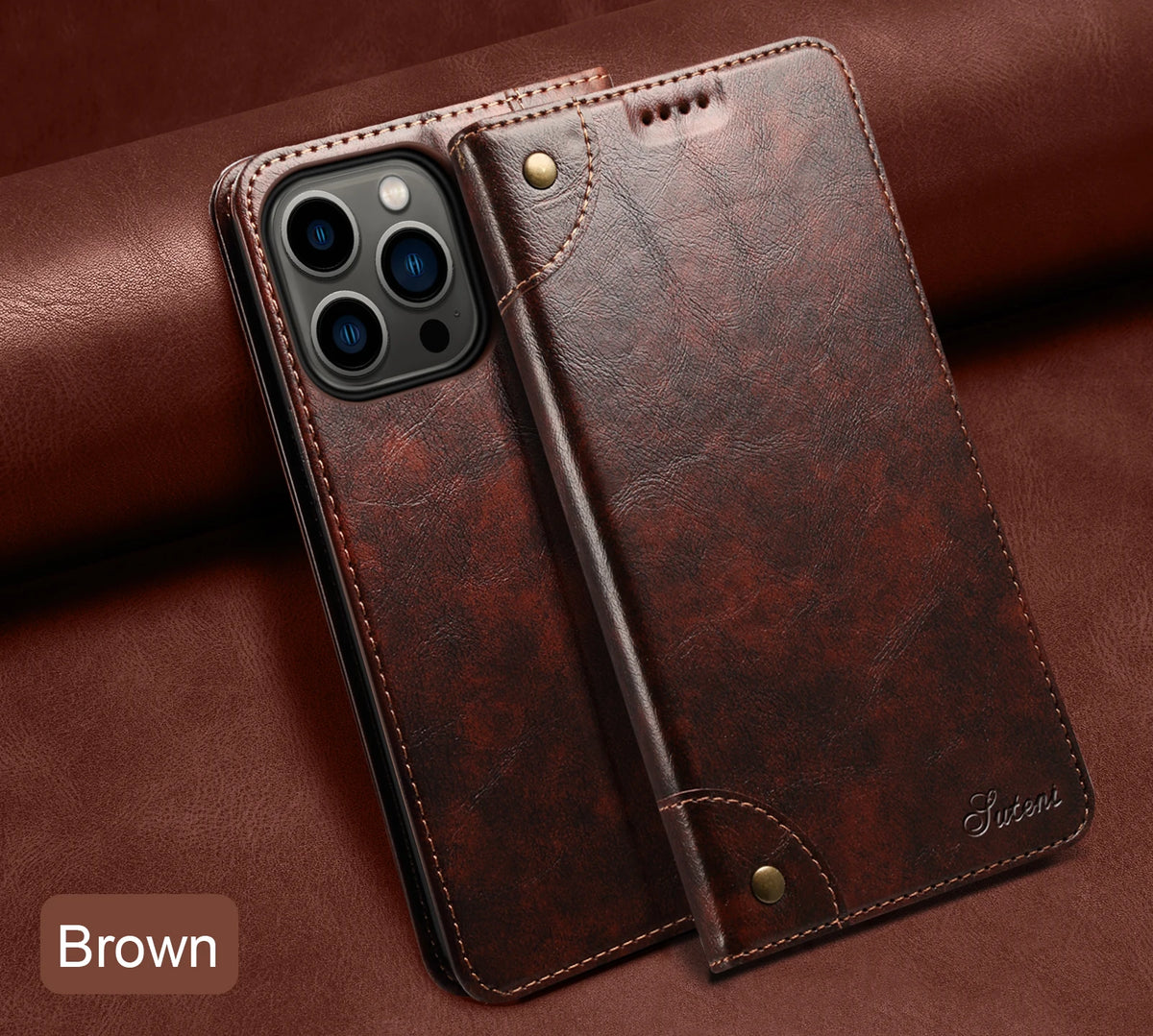 A brown magnetic leather flip case with a camera module is shown resting on a dark brown leather surface.