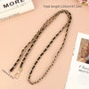 A gold and black leather chain strap for an adjustable crossbody purse is displayed on a light background.