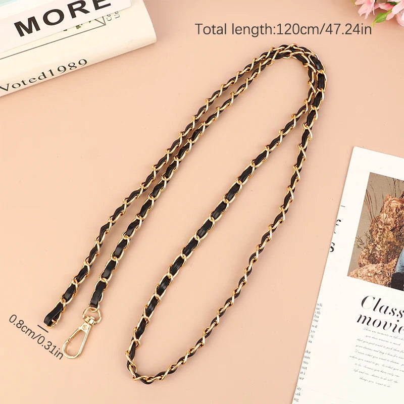 A gold and black leather chain strap for an adjustable crossbody purse is displayed on a light background.