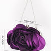 A deep purple rose floral evening clutch bag with a silver chain strap displayed against a white background.