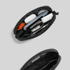 A black travel electronics organizer pouch is shown open, displaying various tools and accessories.