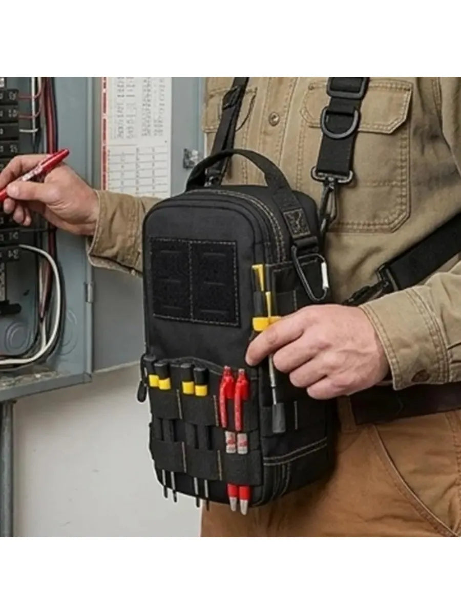 A person holds a black tactical shoulder tool pouch with various tools attached, against a light-colored uniform.