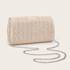 A woven straw envelope clutch with a silver chain strap resting on a light background.