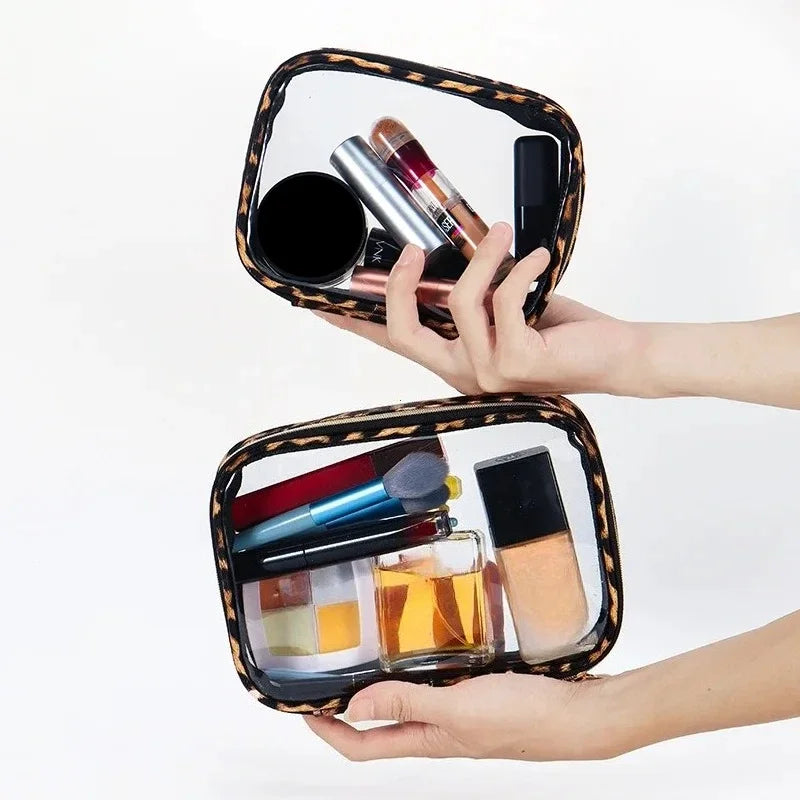 A hand holds a leopard print waterproof cosmetic organizer bag filled with various makeup products.